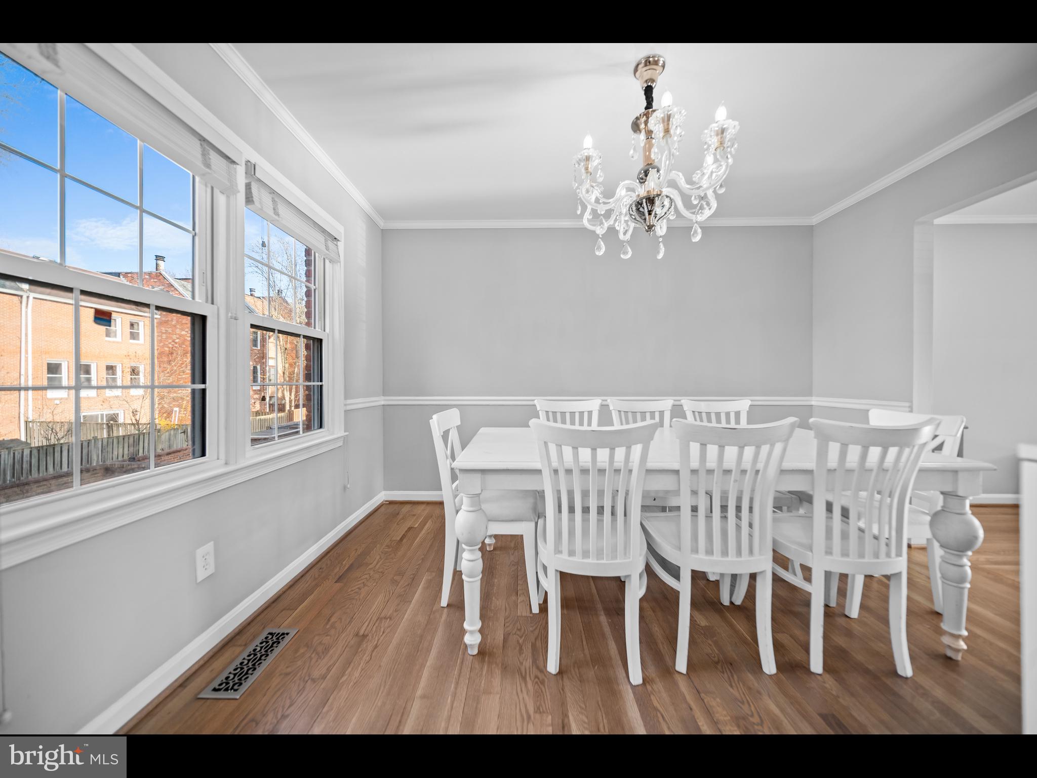 1609 Dunterry Place McLean, VA 22101 - Photo 8 of 36 a view of a dining room with furniture a chandelier and wooden floor