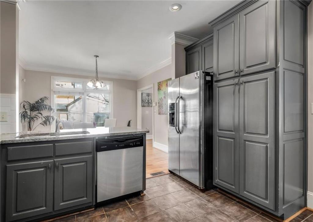 2846 Piedmont Road Northeast, Unit 1 Atlanta, GA 30305 - Photo 14 of 29 a kitchen with stainless steel appliances a refrigerator and cabinets