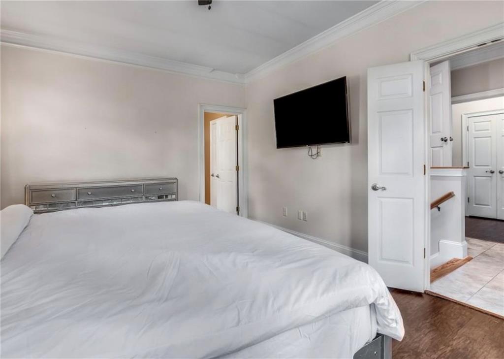 2846 Piedmont Road Northeast, Unit 1 Atlanta, GA 30305 - Photo 18 of 29 a bedroom with a bed and a flat screen tv