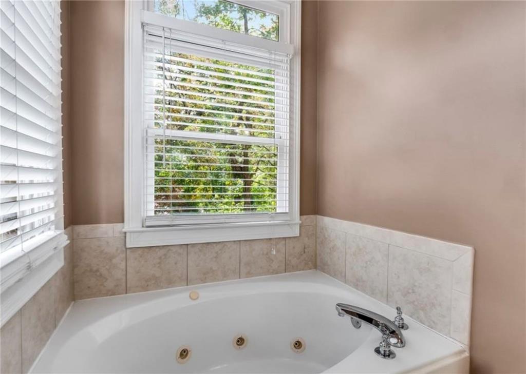 2846 Piedmont Road Northeast, Unit 1 Atlanta, GA 30305 - Photo 20 of 29 a bath tub sitting in a bathroom next to a window