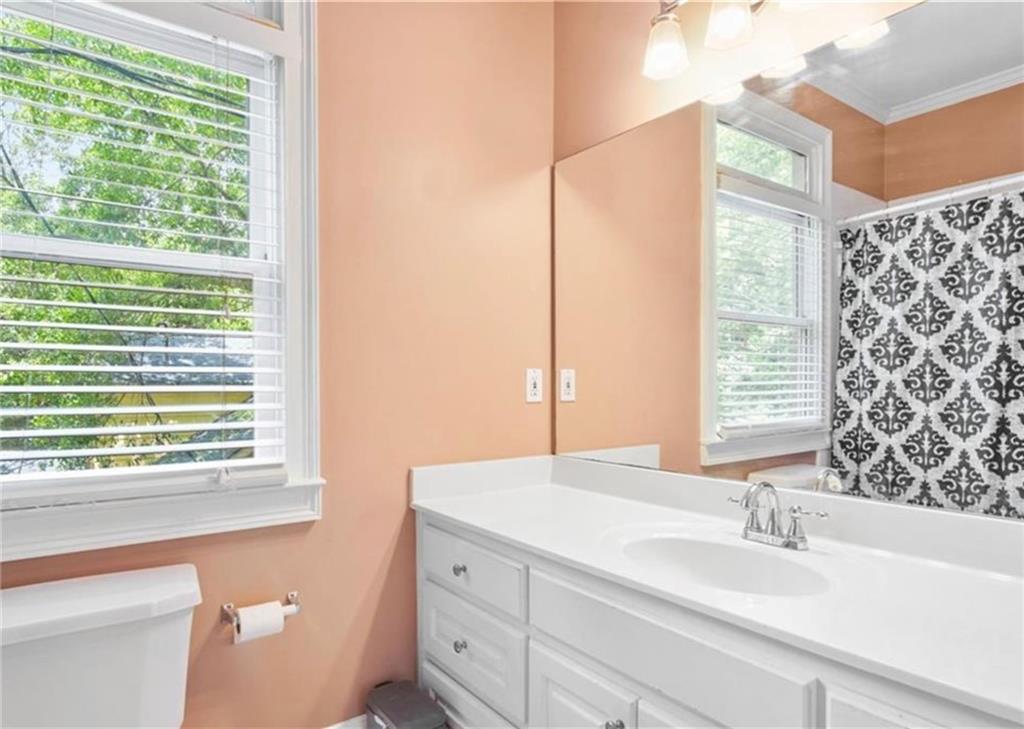 2846 Piedmont Road Northeast, Unit 1 Atlanta, GA 30305 - Photo 21 of 29 a bathroom with a sink and a mirror