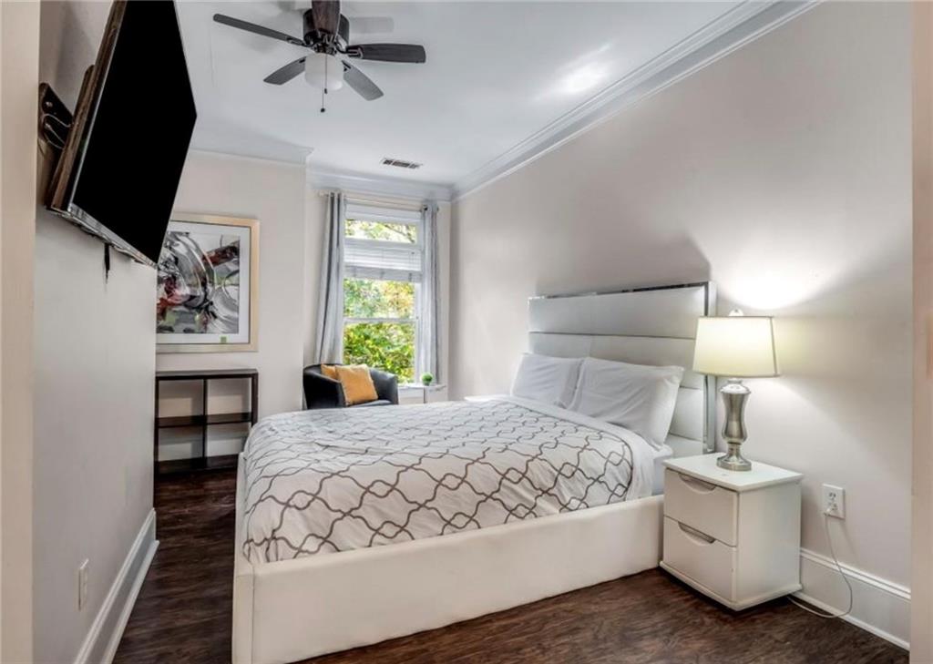 2846 Piedmont Road Northeast, Unit 1 Atlanta, GA 30305 - Photo 23 of 29 a bedroom with a bed and a flat screen tv