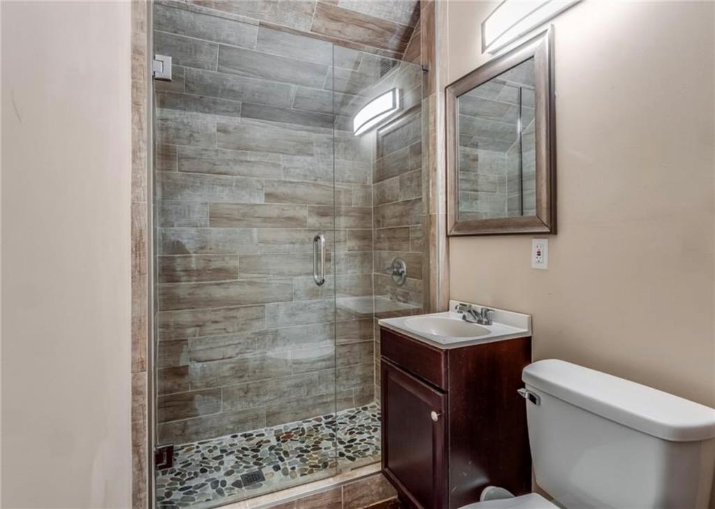 2846 Piedmont Road Northeast, Unit 1 Atlanta, GA 30305 - Photo 27 of 29 a bathroom with a toilet a sink and shower