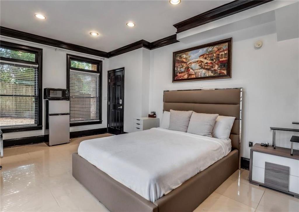 2846 Piedmont Road Northeast, Unit 1 Atlanta, GA 30305 - Photo 3 of 29 a spacious bedroom with a large bed and a large window