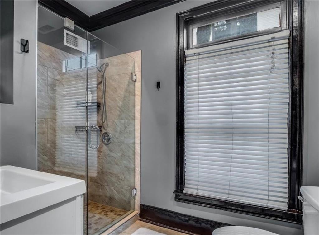 2846 Piedmont Road Northeast, Unit 1 Atlanta, GA 30305 - Photo 5 of 29 a bathroom with a shower and a sink