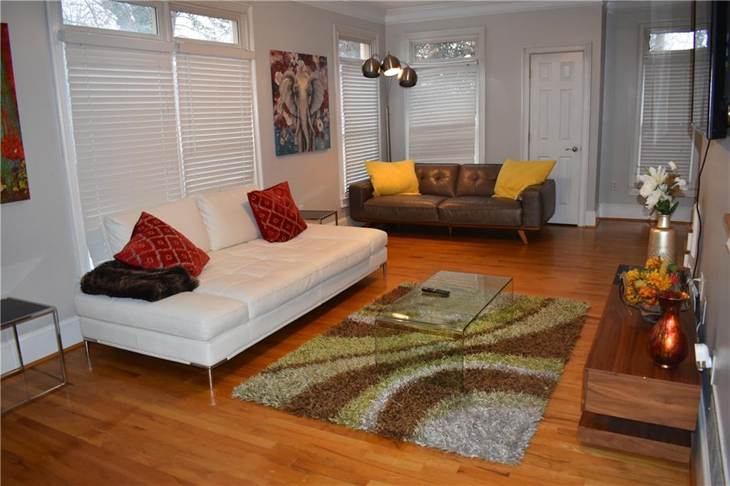 2846 Piedmont Road Northeast, Unit 1 Atlanta, GA 30305 - Photo 7 of 29 a living room with furniture and wooden floor