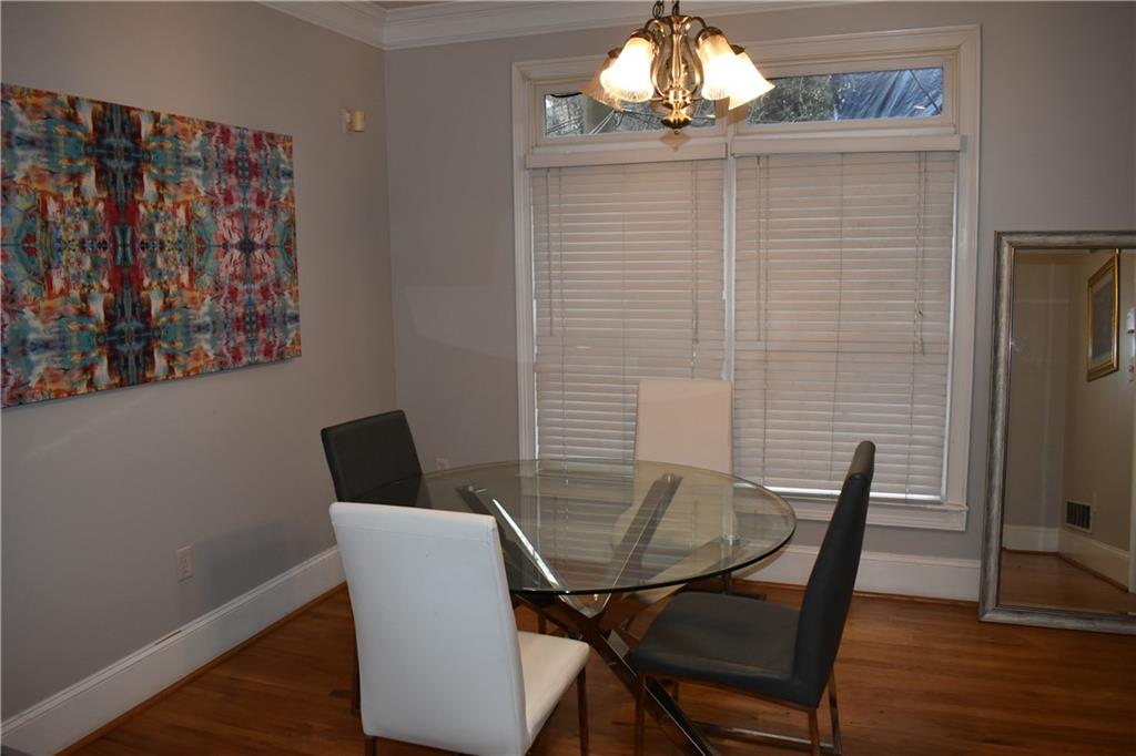 2846 Piedmont Road Northeast, Unit 1 Atlanta, GA 30305 - Photo 9 of 29 a view of a dining room with furniture and wooden floor