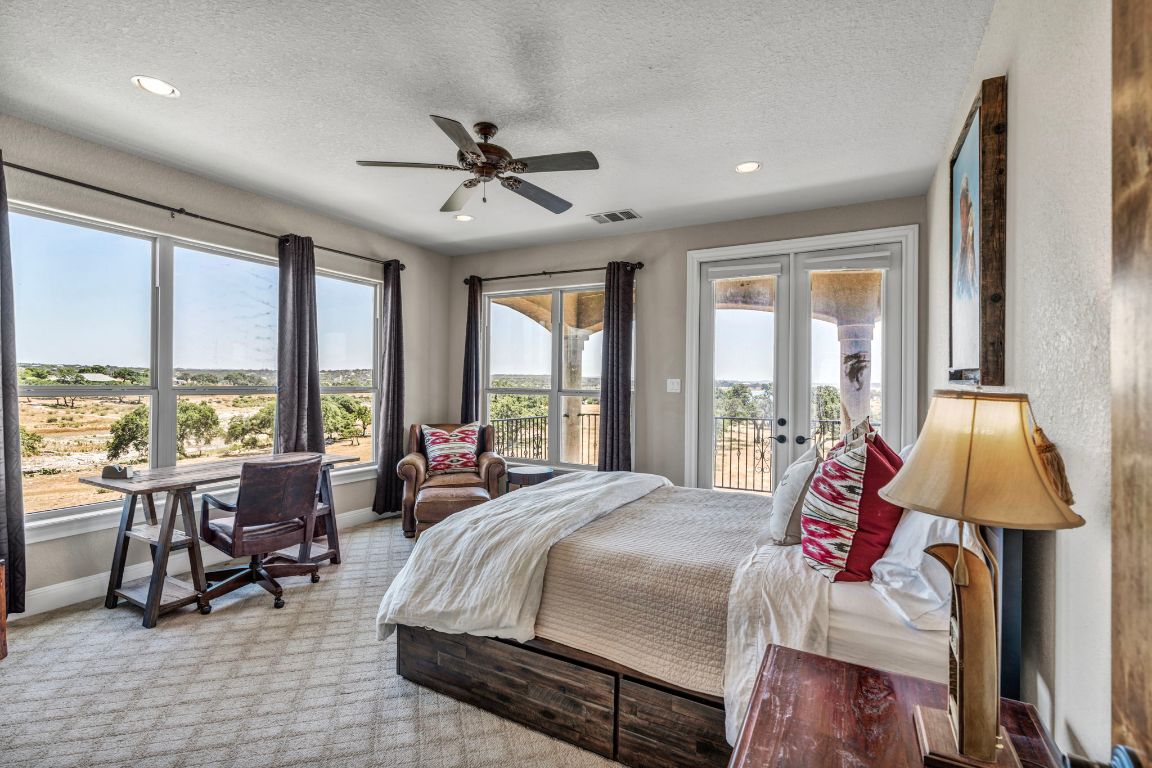144 Serene Street Spring Branch, TX 78070 - Photo 26 of 37 a spacious bedroom with a bed and large windows
