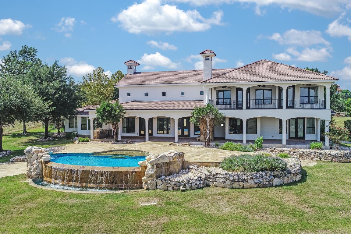 144 Serene Street Spring Branch, TX 78070 - Photo 8 of 37 a front view of a house with swimming pool having outdoor seating