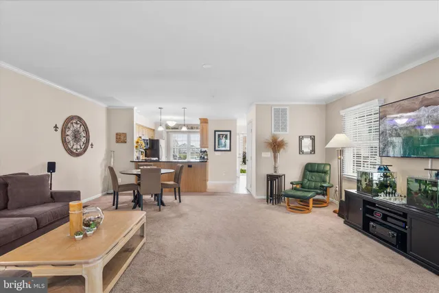a living room with furniture a clock on wall and a window