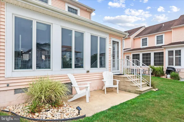 a view of a patio with table and chairs and potted plants