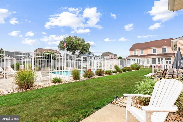 a view of house with a backyard and a patio