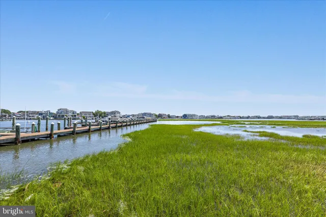 a view of a lake with a car parked on the roadside