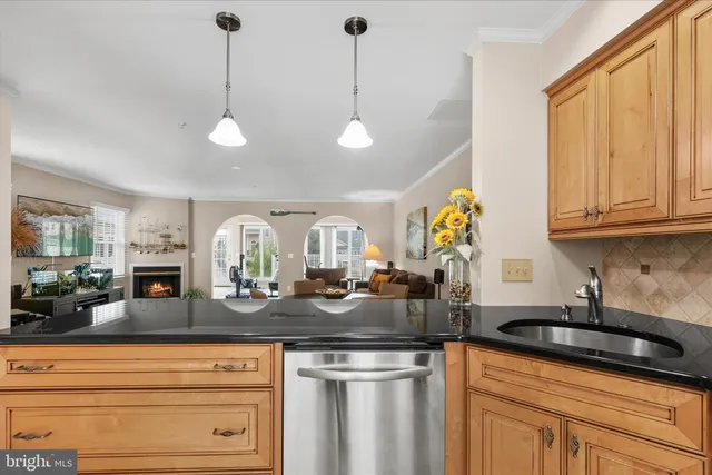 a kitchen with stainless steel appliances granite countertop a sink a stove and cabinets