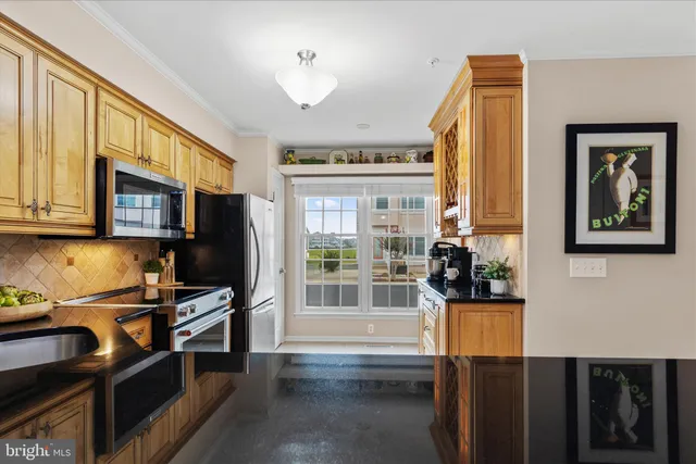 a living room with stainless steel appliances furniture a fireplace and a flat screen tv