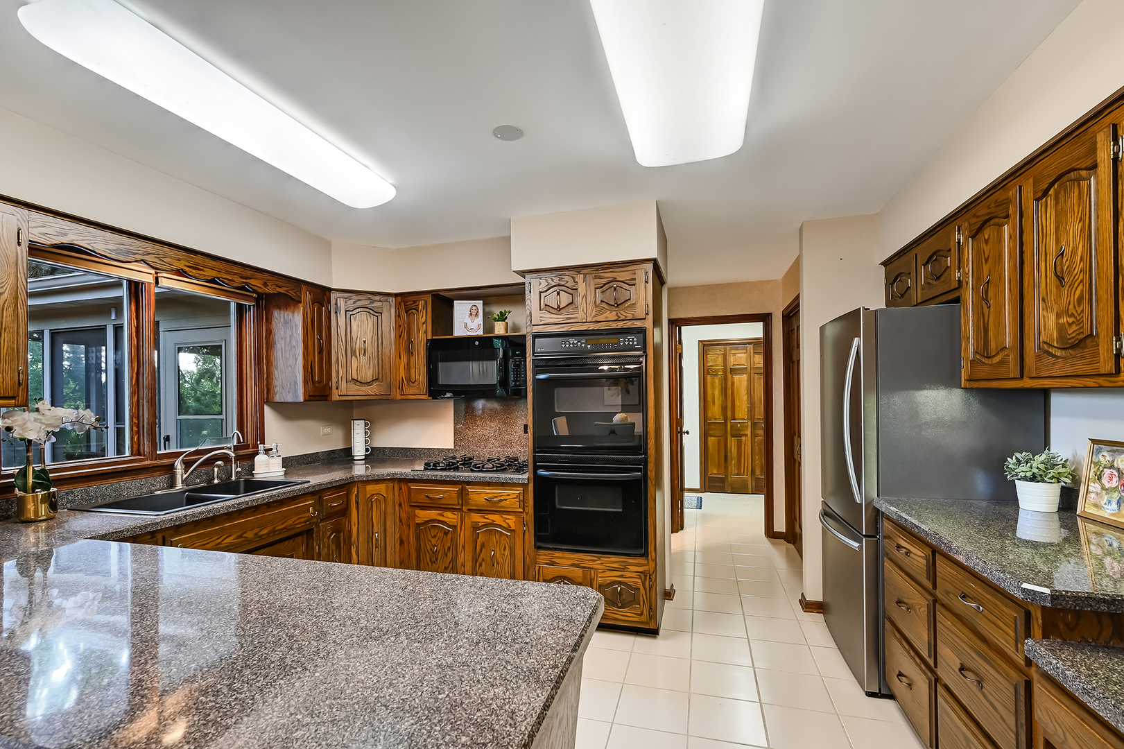 8141 Ridgepoint Drive Burr Ridge, IL 60527 - Photo 9 of 46 a kitchen with stainless steel appliances granite countertop a sink stove and refrigerator