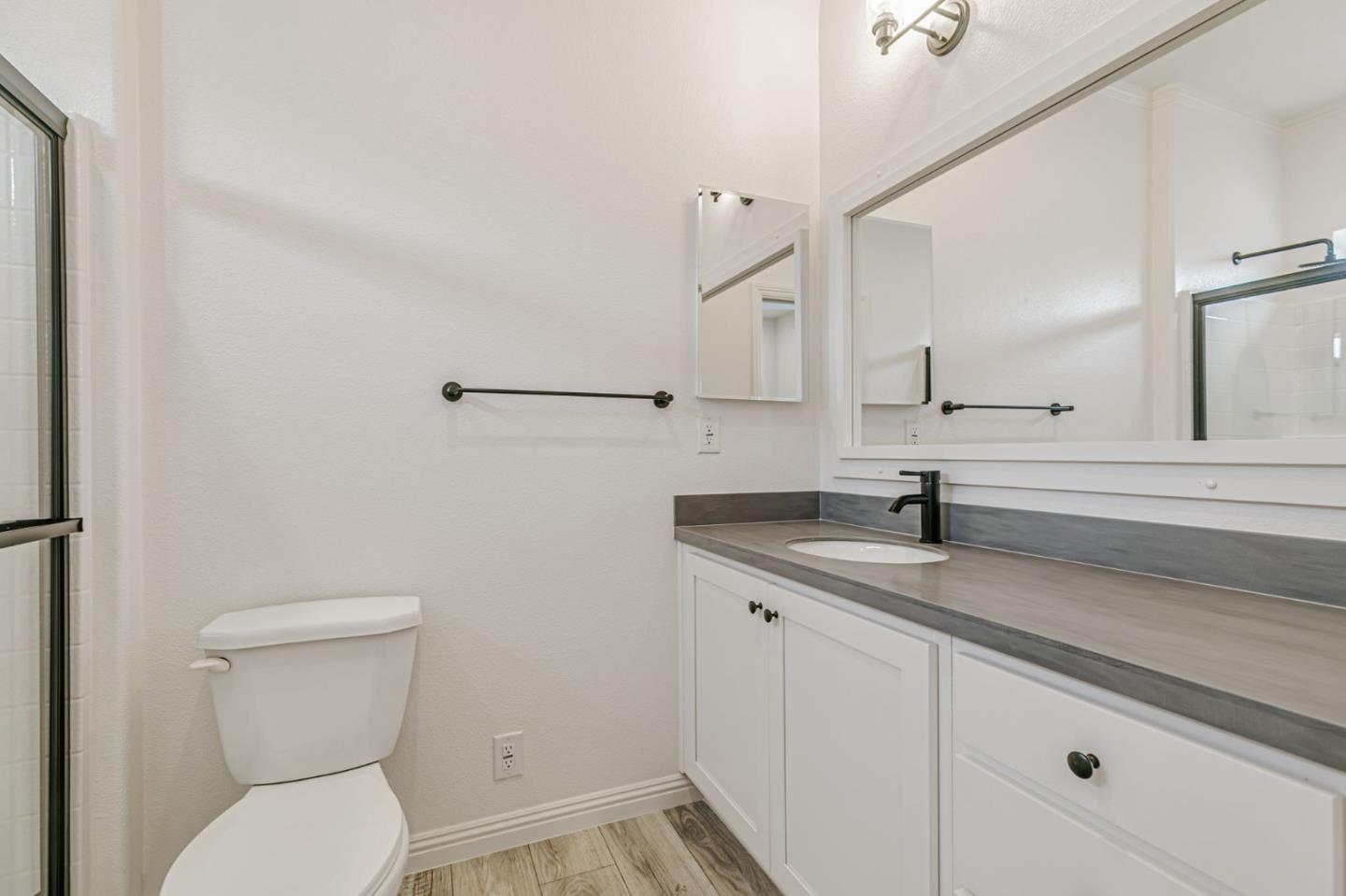 555 Umbarger Road, Unit 131 San Jose, CA 95111 - Photo 26 of 32 a bathroom with a granite countertop toilet sink and mirror