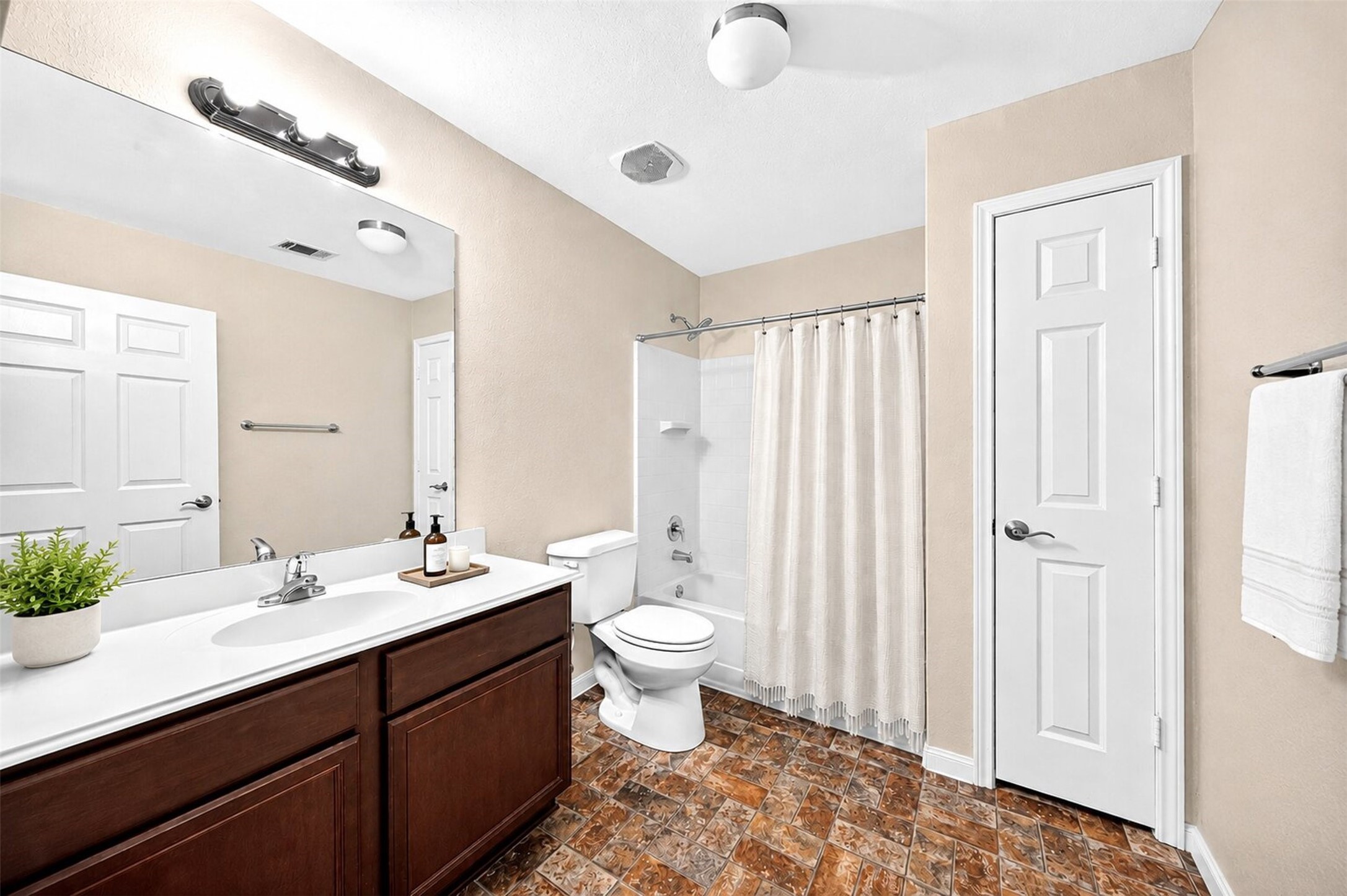 148 Fear Road Winnie, TX 77665 - Photo 21 of 34 Large secondary bath with shower tub combo. Spacious interior design highlights extra-wide doors for all bedrooms and bathrooms. Bathroom virtually staged.