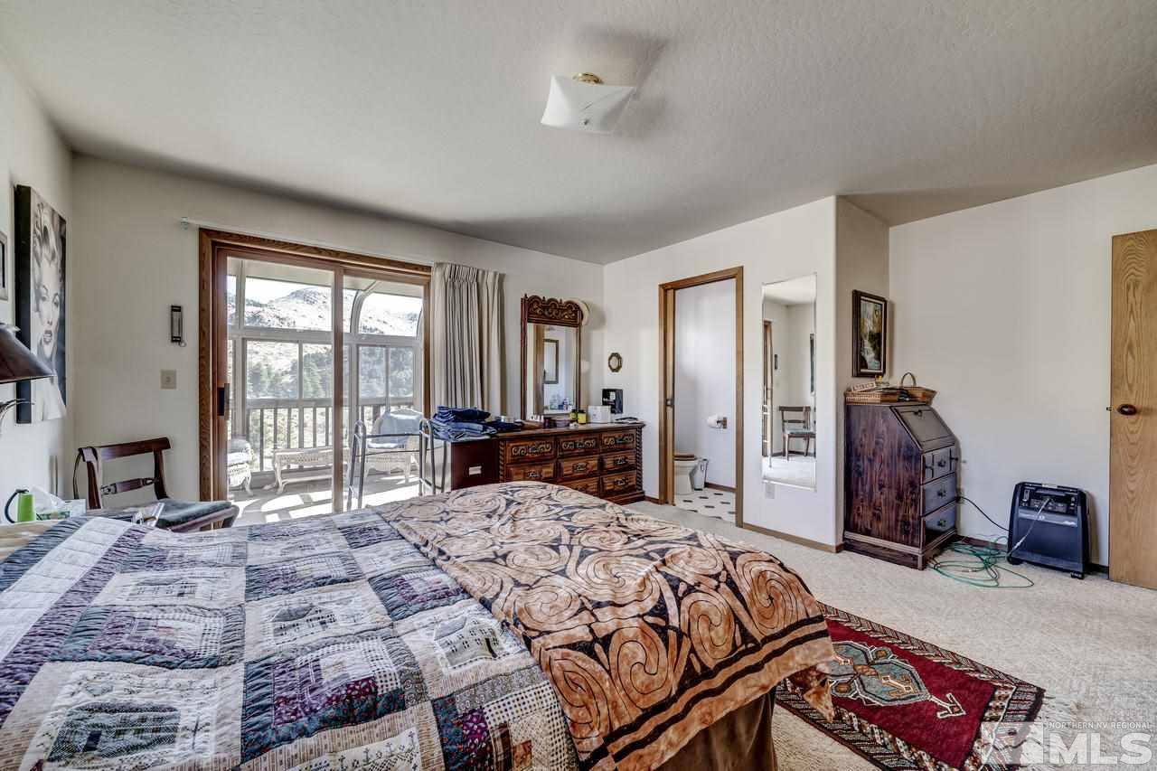 16500 Toll Road Reno, NV 89521 - Photo 11 of 25 a bedroom with a large bed and a large window