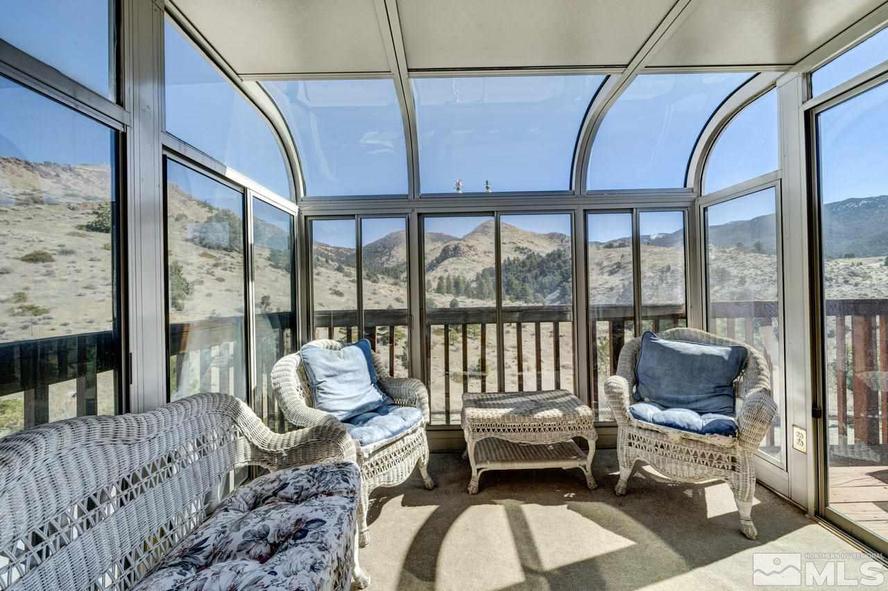 16500 Toll Road Reno, NV 89521 - Photo 12 of 25 a living room with furniture and a floor to ceiling window