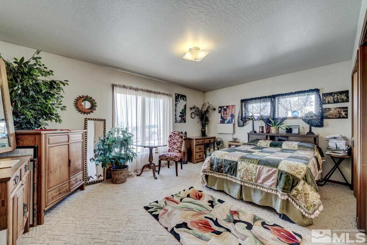 16500 Toll Road Reno, NV 89521 - Photo 13 of 25 a bedroom with furniture and a potted plant