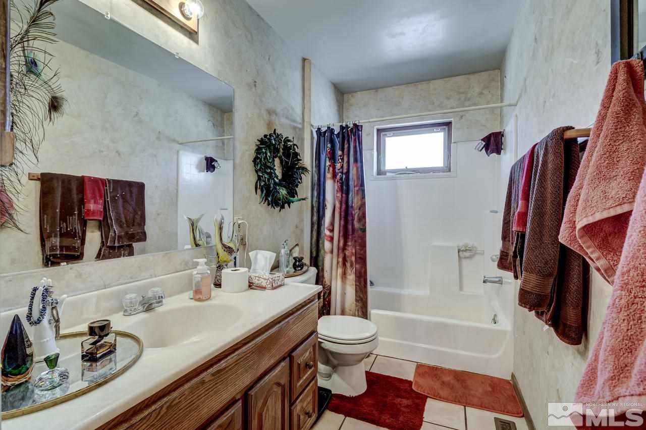 16500 Toll Road Reno, NV 89521 - Photo 14 of 25 a bathroom with a sink toilet and shower