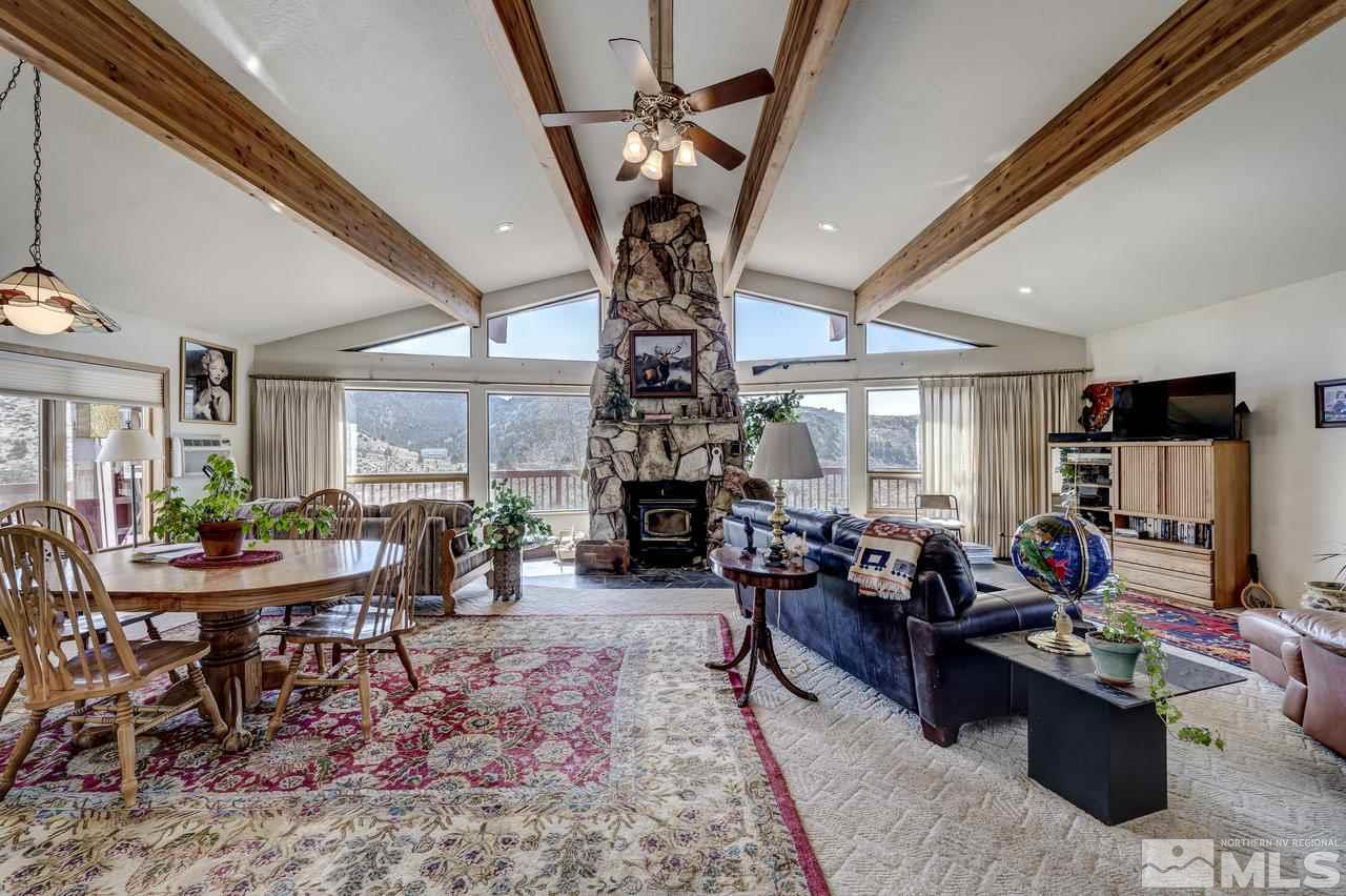16500 Toll Road Reno, NV 89521 - Photo 4 of 25 a living room with fireplace furniture and a chandelier