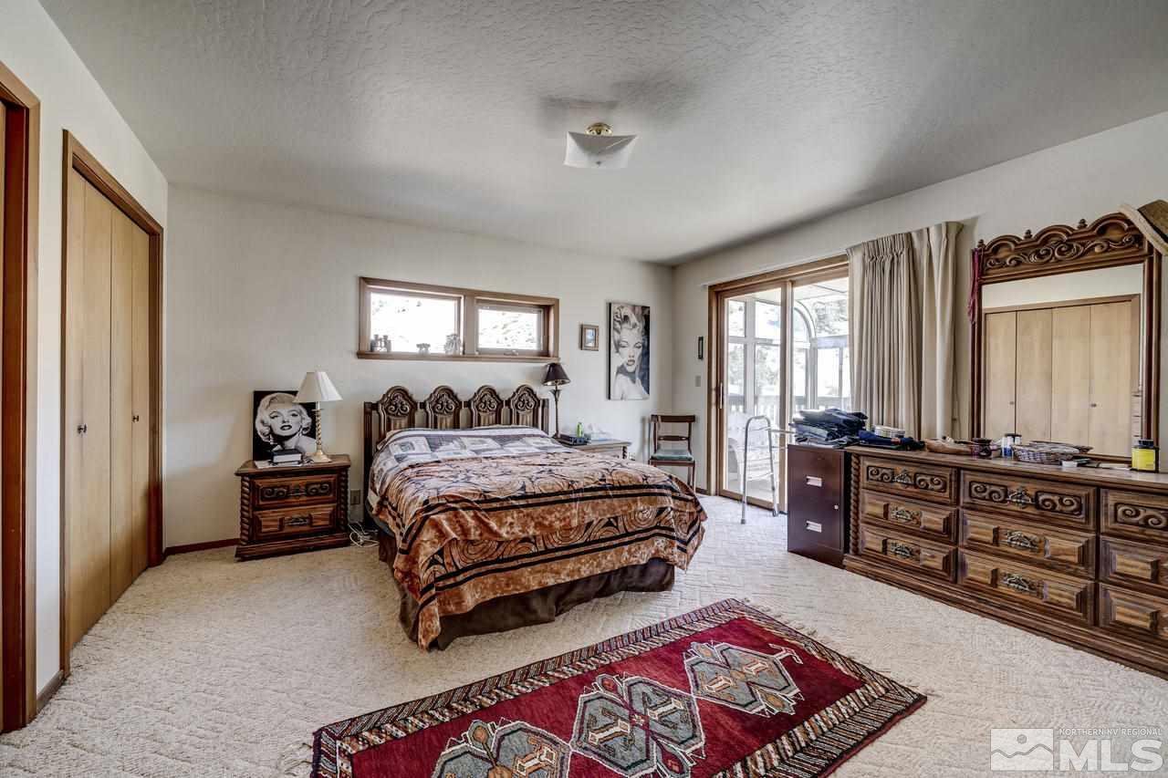 16500 Toll Road Reno, NV 89521 - Photo 10 of 25 a spacious bedroom with a bed window and dresser
