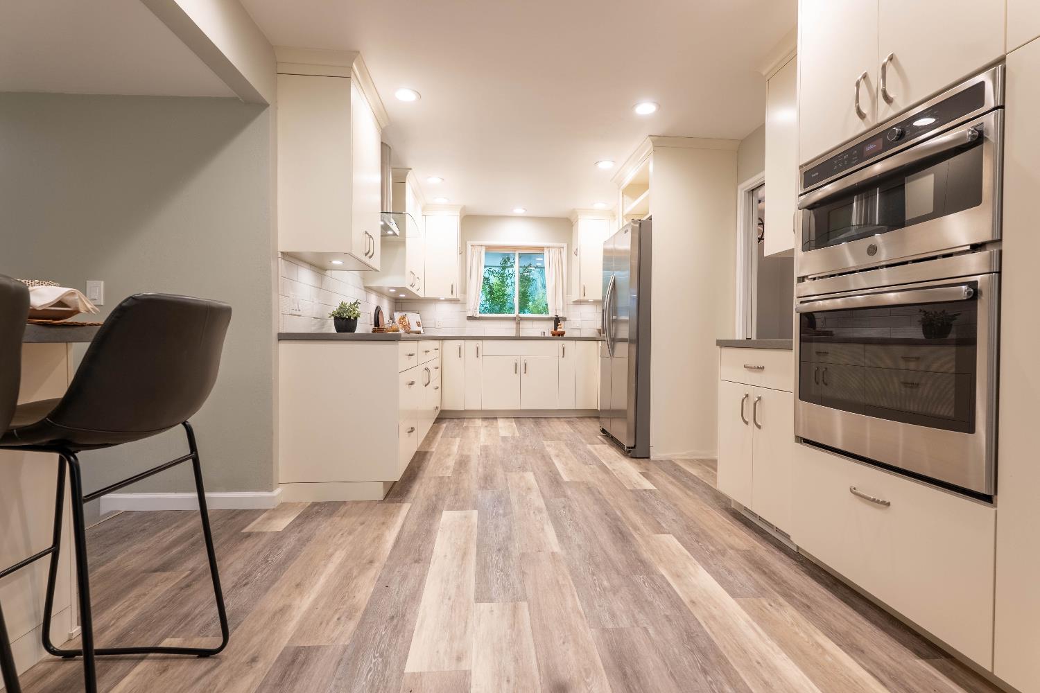 4631 Nickles Way Sacramento, CA 95864 - Photo 13 of 40 a kitchen with a wooden floor and white appliances