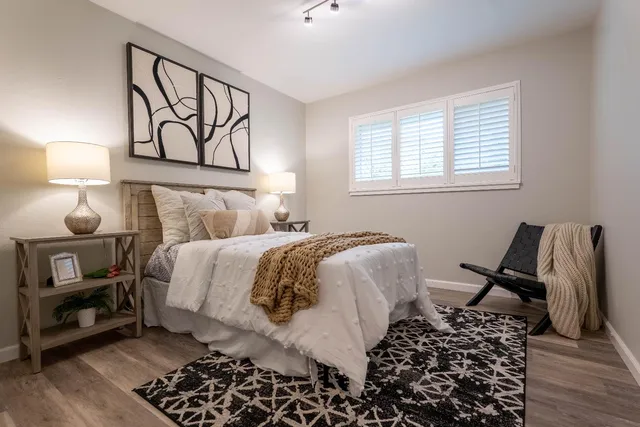 a bedroom with a bed and wooden floor