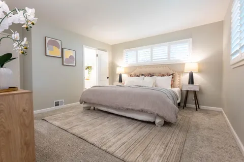 a bedroom with a bed and window