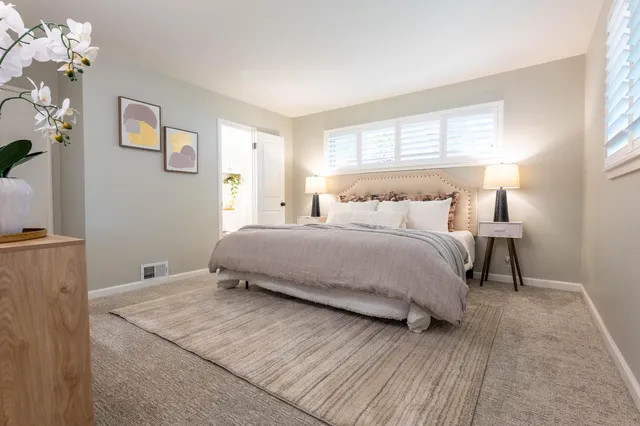 a bedroom with a bed and window