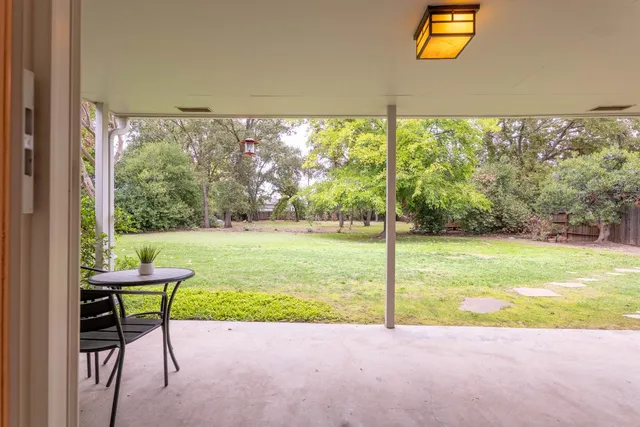 a view of a swimming pool and a yard