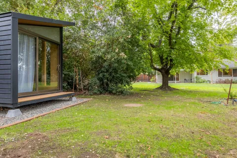 a view of a house with a yard and tree s