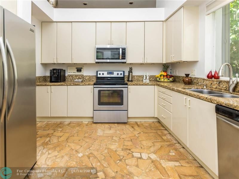 6334 Northwest 24th Street Boca Raton, FL 33434 - Photo 21 of 45 a kitchen with stainless steel appliances granite countertop a stove a sink dishwasher and a refrigerator