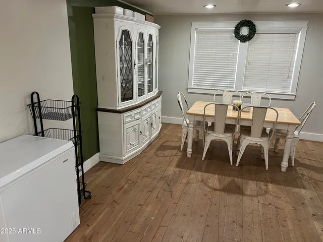 a view of a dining room with furniture and a window