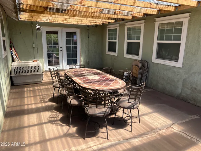 a view of a patio with table and chairs