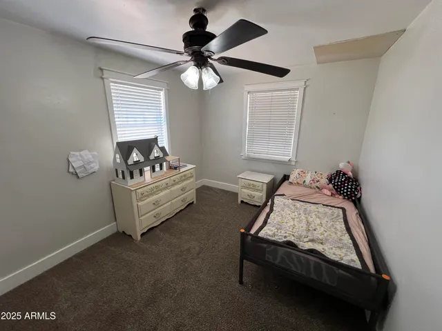 a bedroom with bed and window