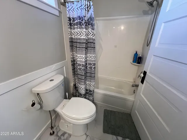 a bathroom with a toilet and shower