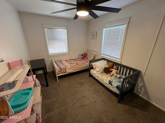 a bedroom with bed and a window