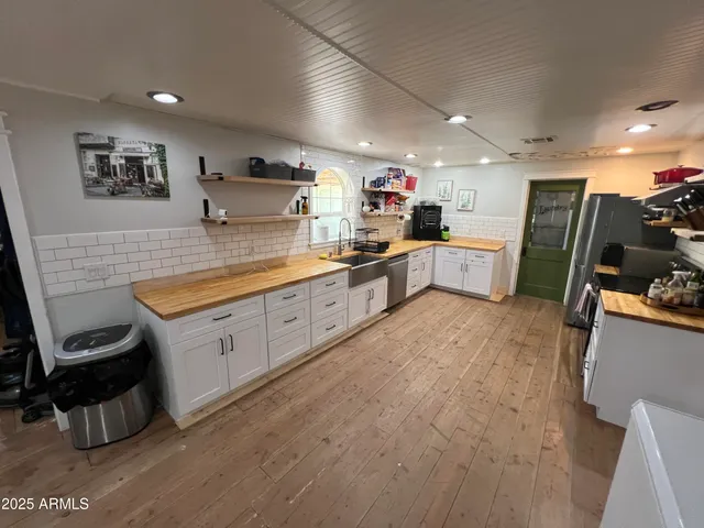 a kitchen with a sink appliances and cabinets