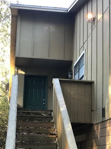 a kitchen with a refrigerator sink and cabinets