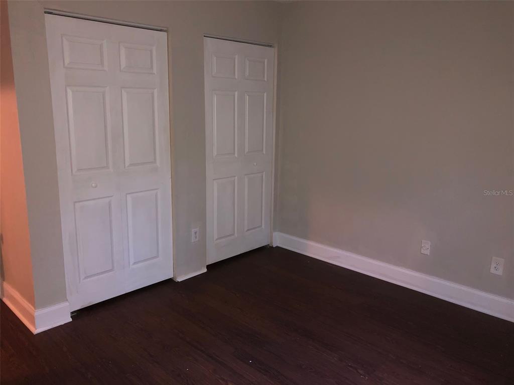 7213 Southwest 44th Place, Unit 6 Gainesville, FL 32608 - Photo 6 of 12 a view of an empty room with wooden floor