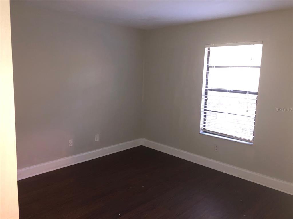 7213 Southwest 44th Place, Unit 6 Gainesville, FL 32608 - Photo 7 of 12 an empty room with a window