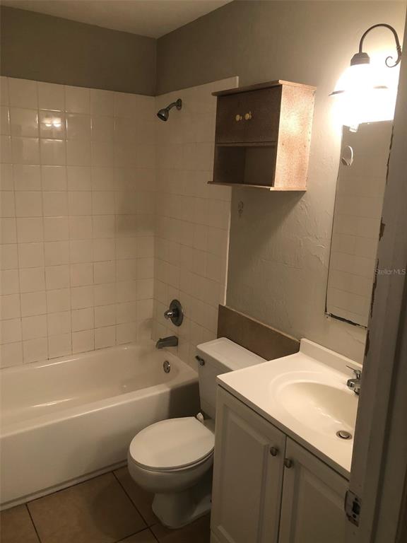 7213 Southwest 44th Place, Unit 6 Gainesville, FL 32608 - Photo 9 of 12 a bathroom with a sink toilet and shower