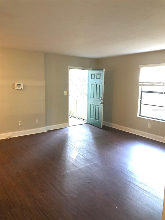 7213 Southwest 44th Place, Unit 6 Gainesville, FL 32608 - Photo 10 of 12 a view of a room with wooden floor and window