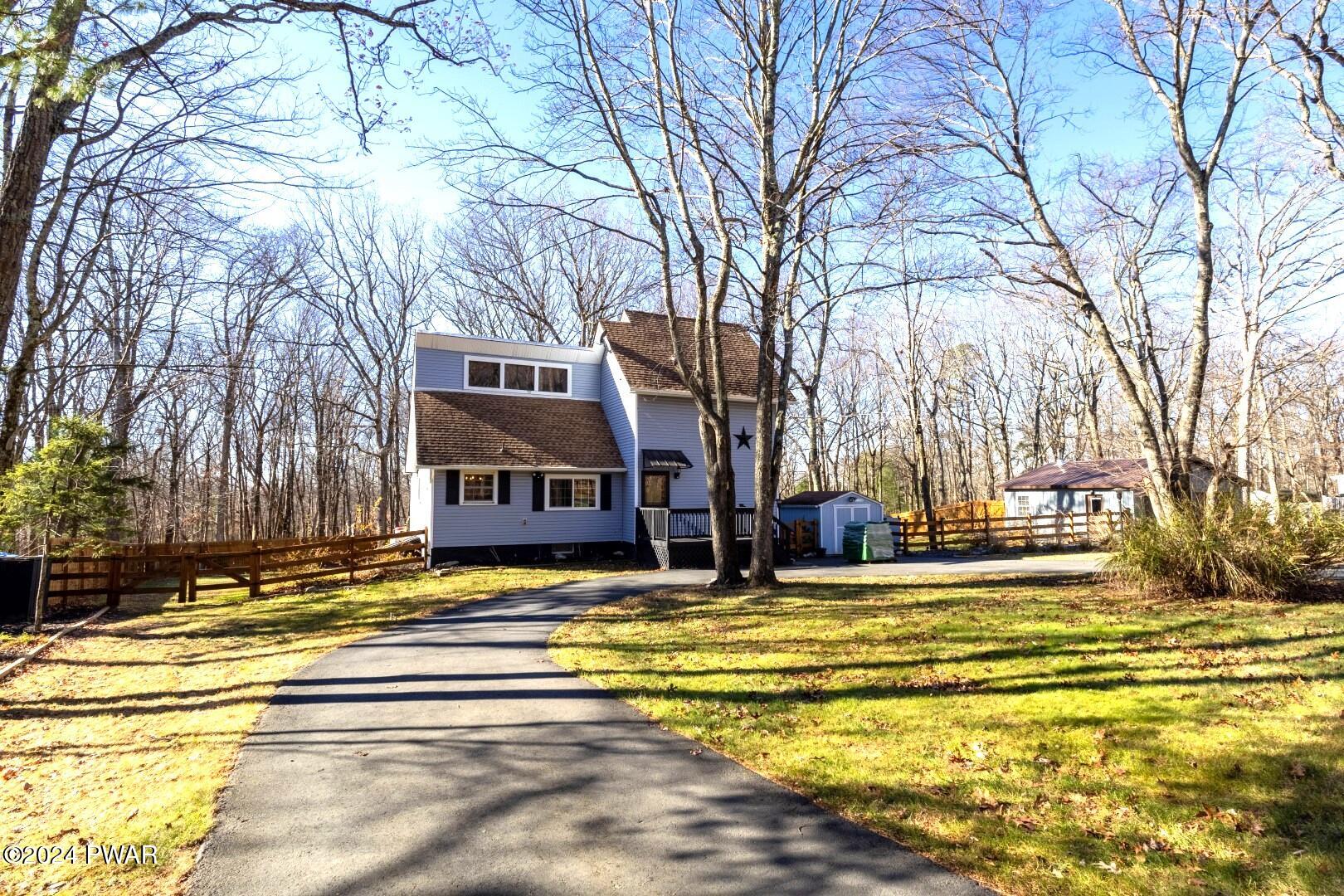 137 Stonehenge Road Milford, PA 18337 - Photo 1 of 30 a view of a swimming pool with a house in the background