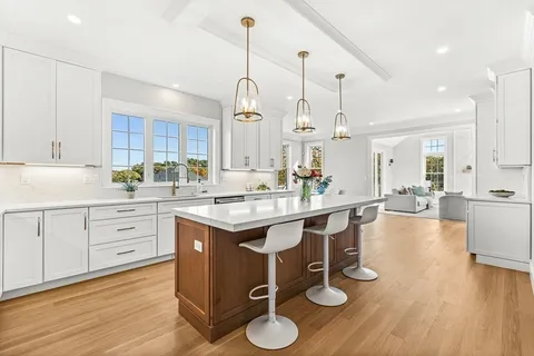 a kitchen with sink refrigerator and cabinets
