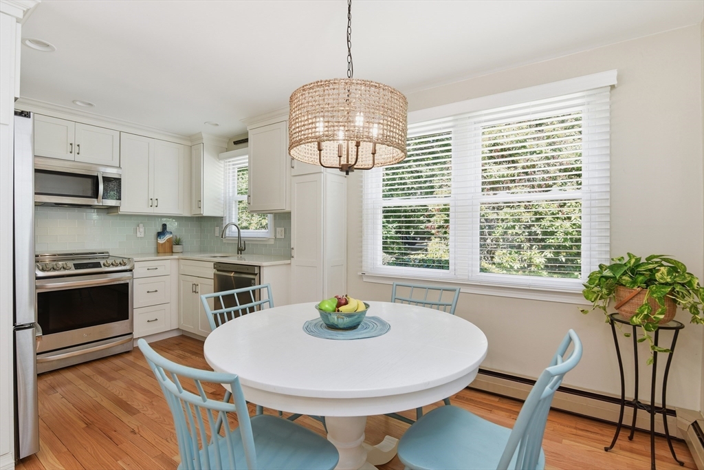 8 Emerald Way Sandwich, MA 02644 - Photo 9 of 36 a kitchen with stainless steel appliances a dining table and chairs