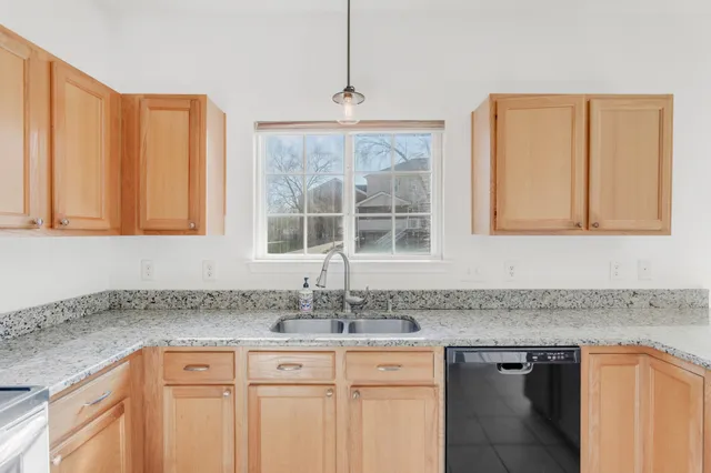 a view of a kitchen with a refrigerator cabinets and a sink